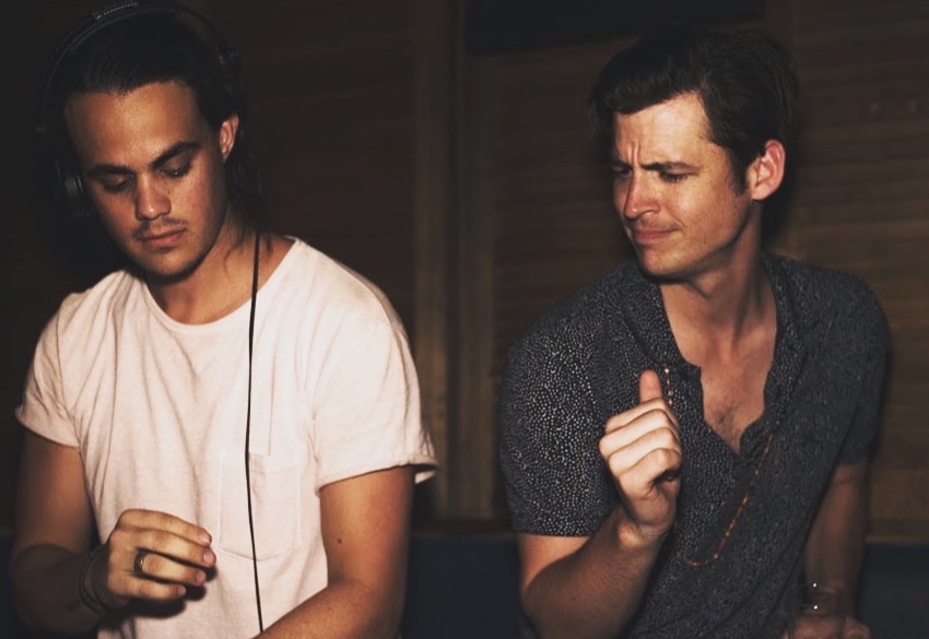 Andrew Smith, at right, dancing beside a DJ in headphones behind the decks.